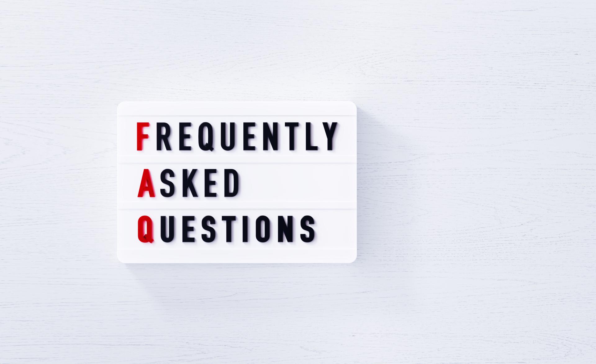 FAQ Written White Lightbox On White Wood Background